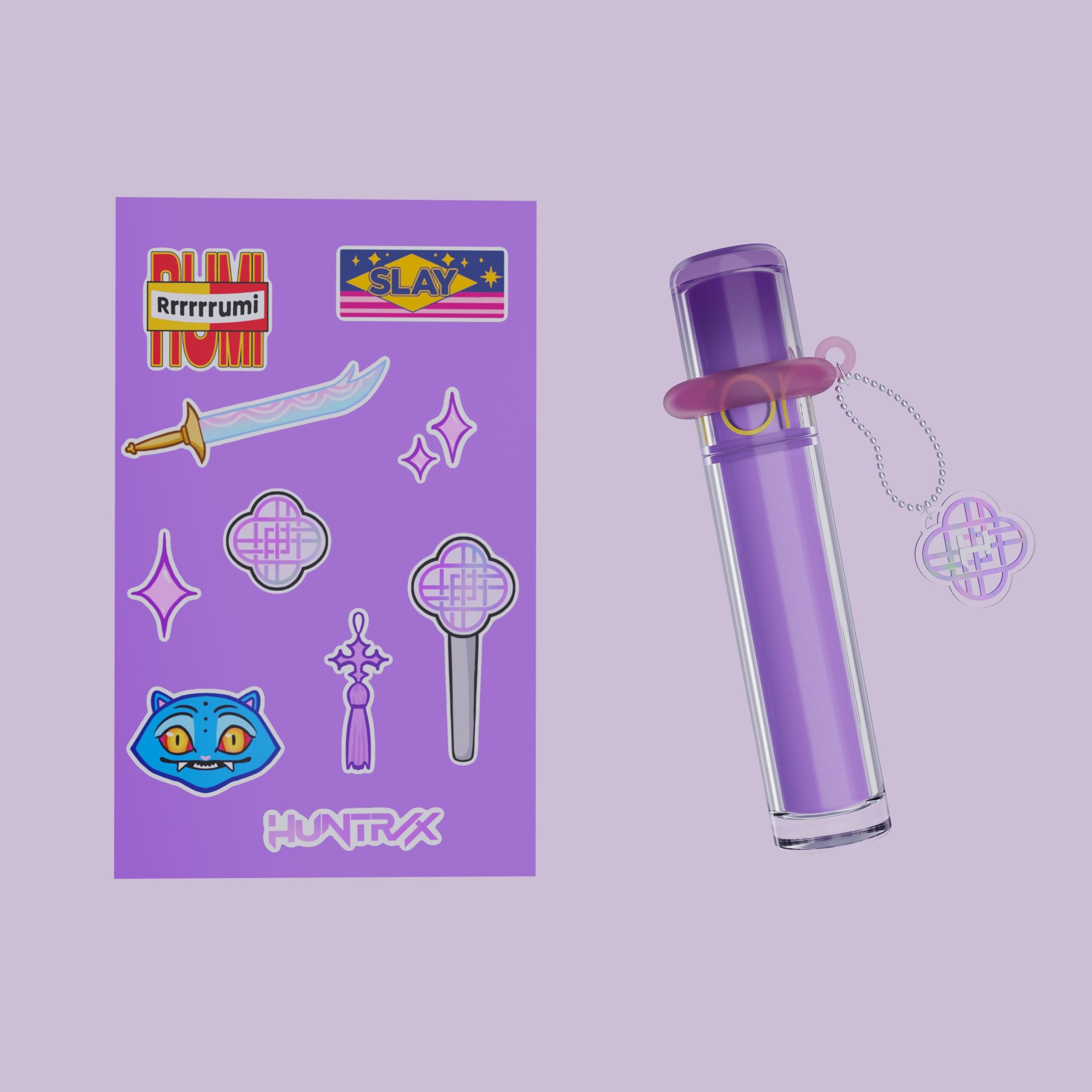 Huntrix sticker sheet next to a purple lip gloss with a charm keychain
